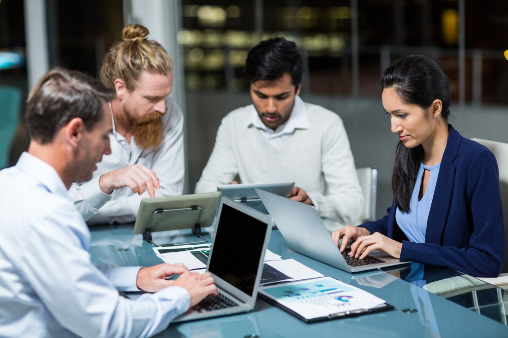 Businesspeople assessing how to choose a software to fulfill orders for their B2B company.