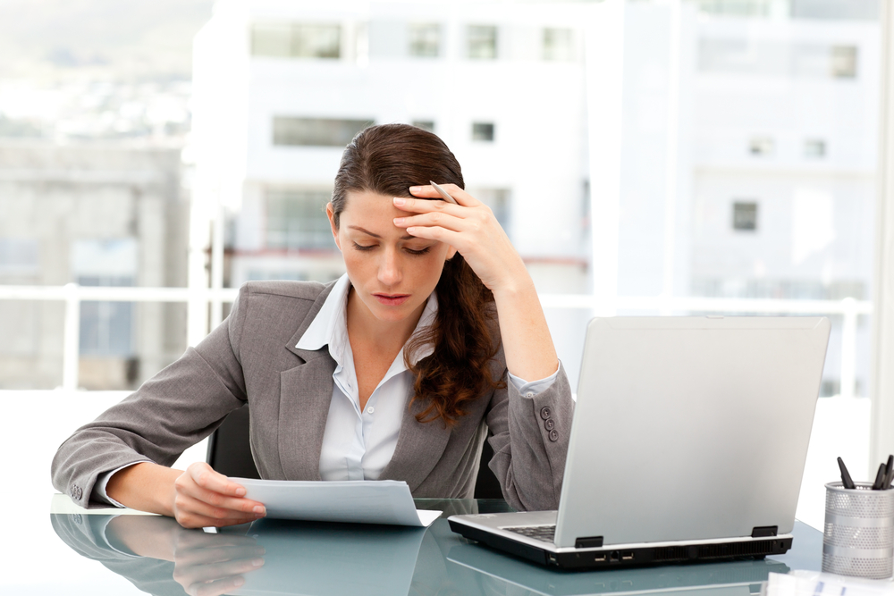 Businesswoman reviewing errors from manually entered data in QuickBooks.